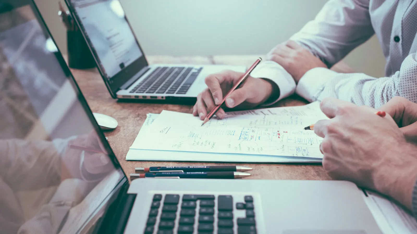 Architectural blueprints and planning documents spread on a desk